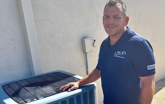 Tri-R tech standing next to newly installed unit